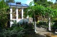 This small greenhouse nestles within the existing backyard garden.